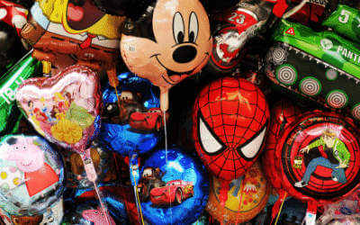 Lots of kids balloons bunched together. Including micky mouse, spider man, pepper the pig and many more
