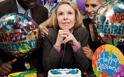 Lady with happy retirement balloons celebrating with work colleagues
