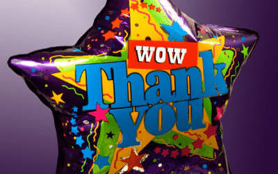 A purple wow thank you balloon with party streamers and stars